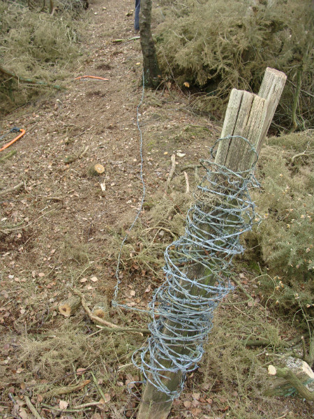 Rolling up barbed wire